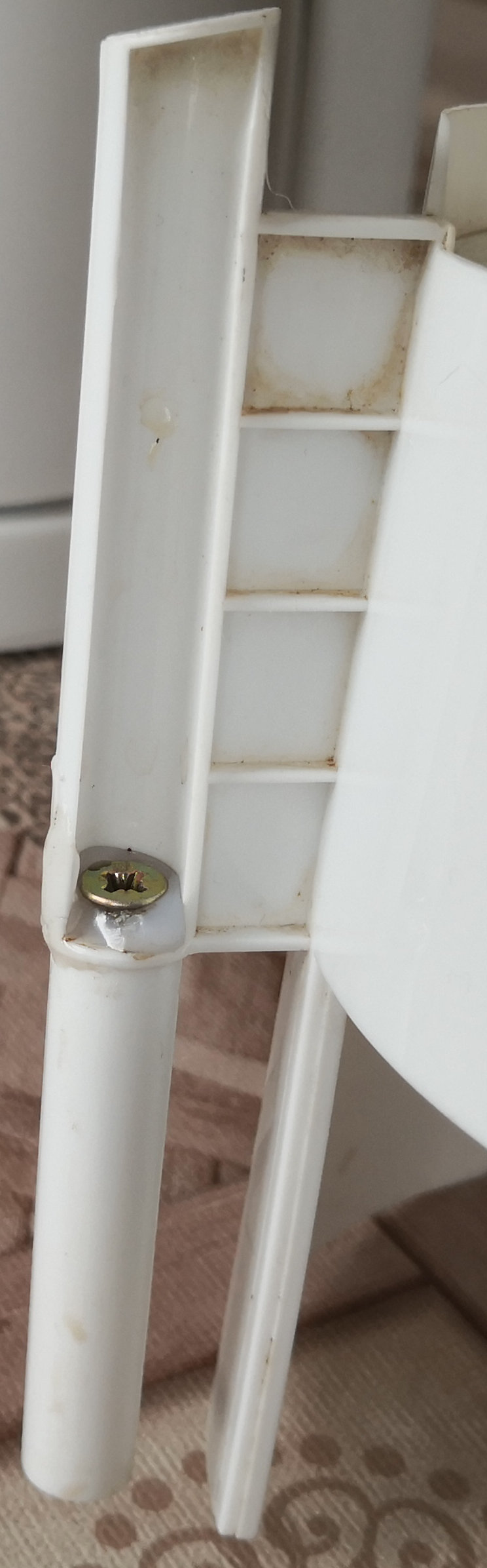 Macro shot. Spax screw holding the two parts together. The screw is molten into hot glue.